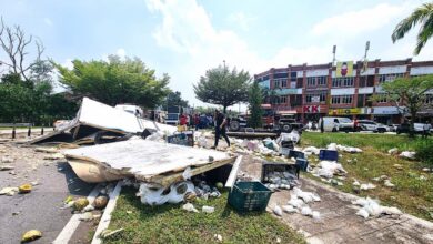 Lorry carrying fruits and vegetables overturns in Shah Alam, driver trapped
