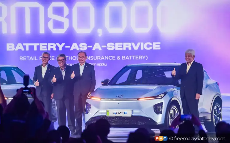 Prime Minister Anwar Ibrahim (third left) at the launch of Perodua’s QV-E electric vehicle today.