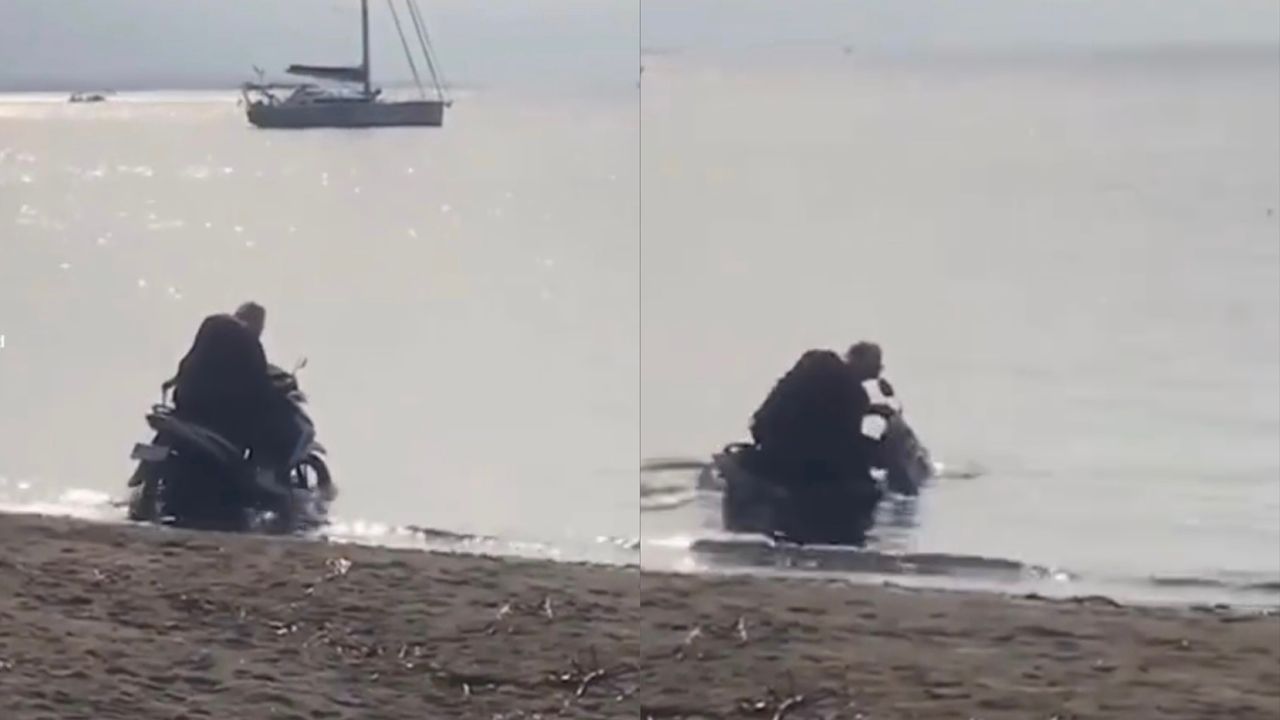 Pelancong tunggang motosikal dalam laut